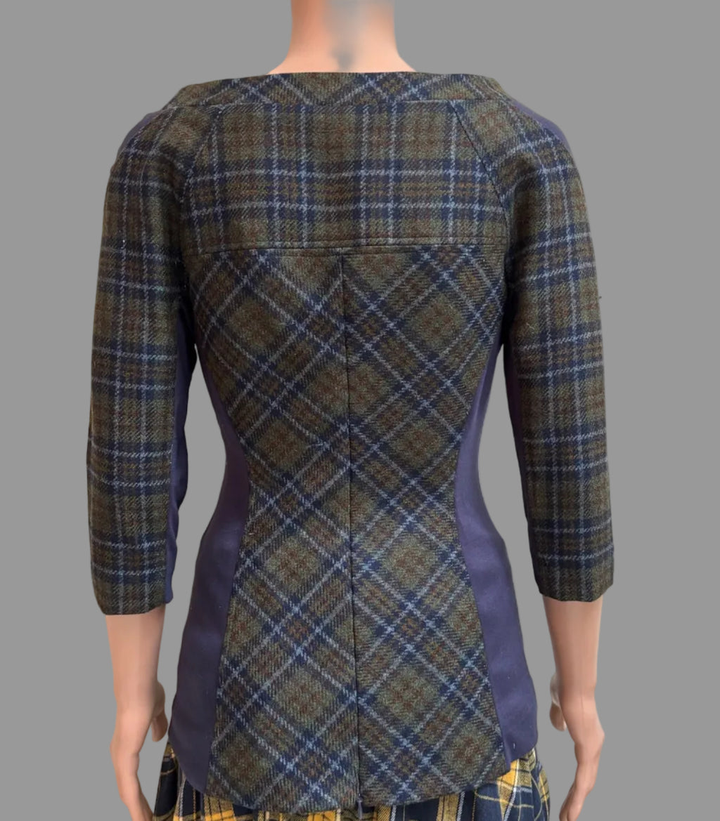 A women's waistcoat or jacket shown from the back on a mannequin, featuring a brown and blue plaid pattern with solid navy side panels and a yellow plaid skirt visible below.