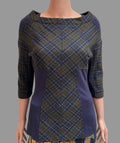 A women's three-quarter sleeve top displayed on a mannequin torso, featuring a blue and brown plaid pattern with solid navy blue side panels and a boat neckline, paired with a matching plaid skirt in front of a white paneled door.