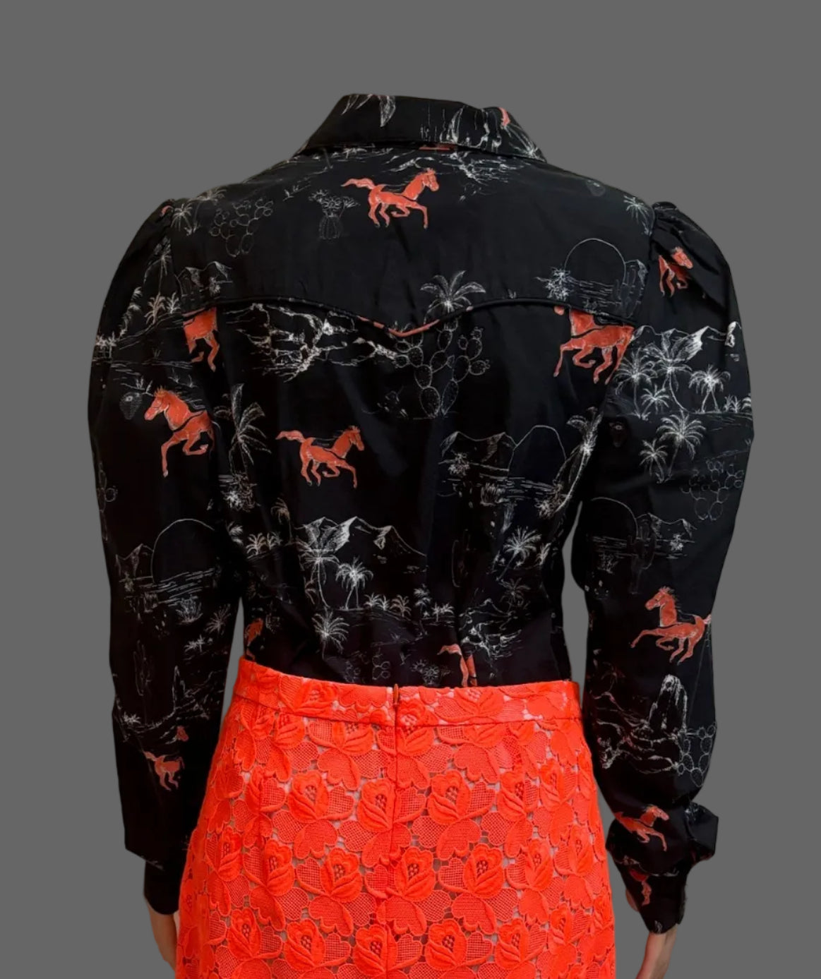 Back view of ASOS black horse print puffy sleeve blouse styled with orange lace mini skirt