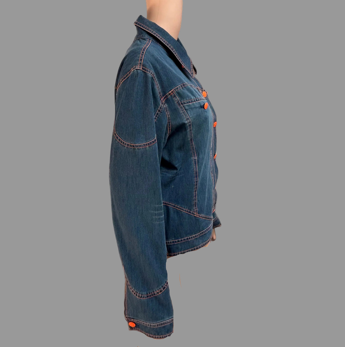Denim jacket on a mannequin against a curtain with a bathroom in the background