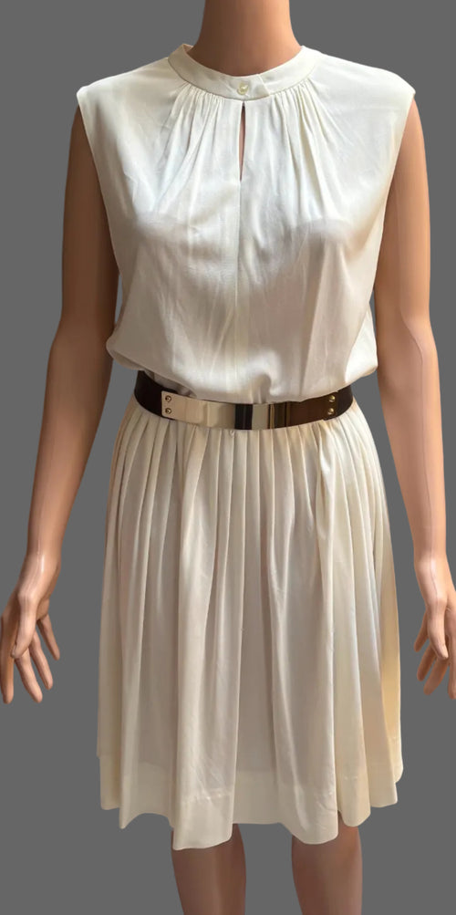White dress on a mannequin with a brown curtain background