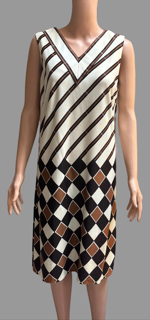 Mannequin wearing a patterned dress against a plain background