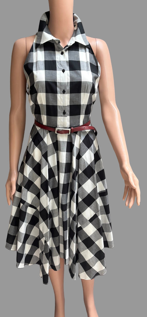 Black and white checkered dress on a mannequin against a plain background