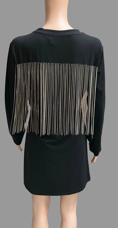 Black dress with silver fringe on a mannequin against a neutral background